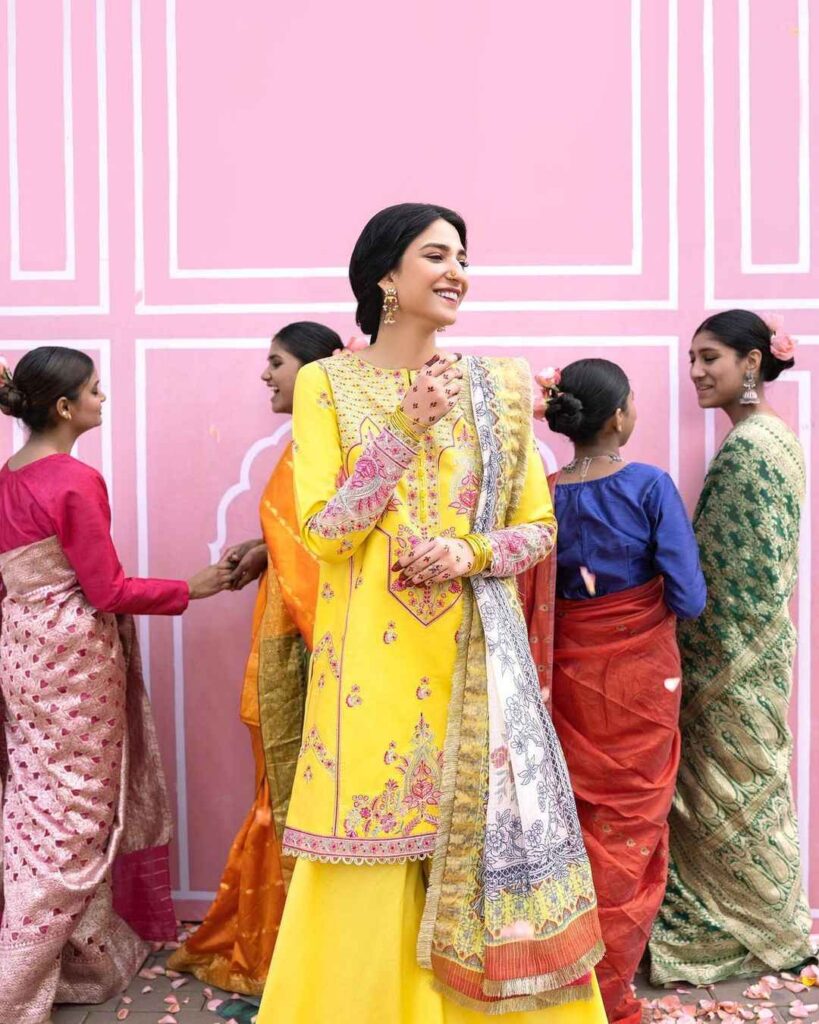 Ramsha Khan Wearing So Kamal yellow wide pose